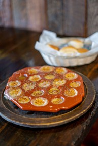 Grilled provoleta with oregano and olive oil, served with freshly baked bread