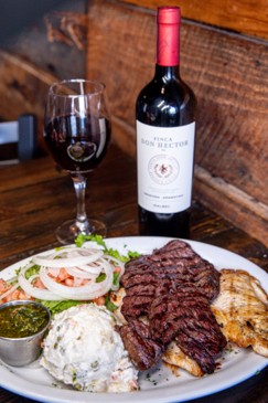 Chimichurri sauce made with garlic, parsley, oil, and vinegar, served alongside grilled steak