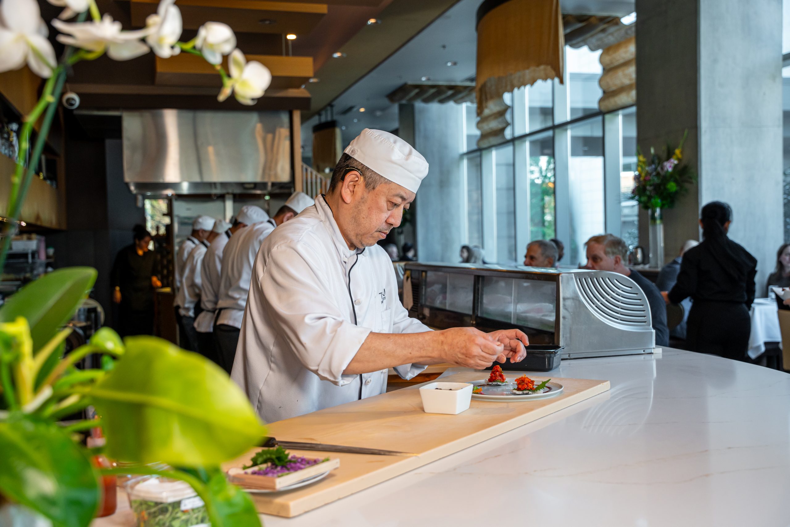 The chef at work behind the counter at Tomo Japanese